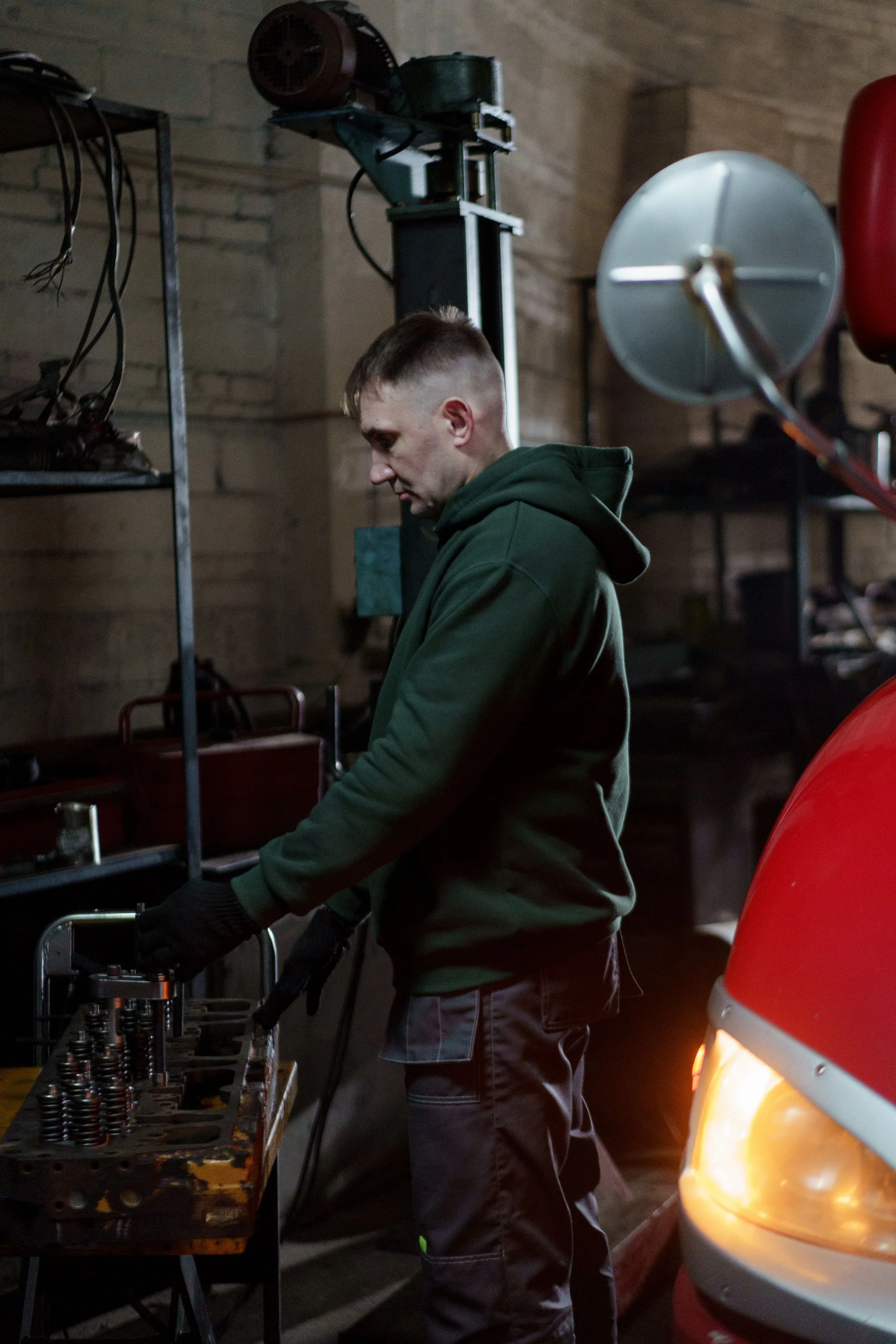 Technician carefully working under the hood of a vehicle